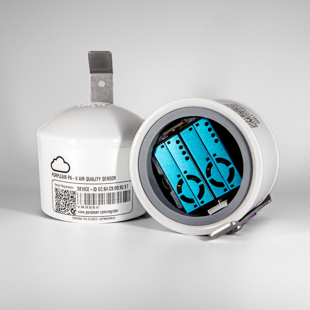 Nowoczesny domowy czujnik jakości powietrza stoi na stoliku w salonie wyświetlając zielone wskaźniki